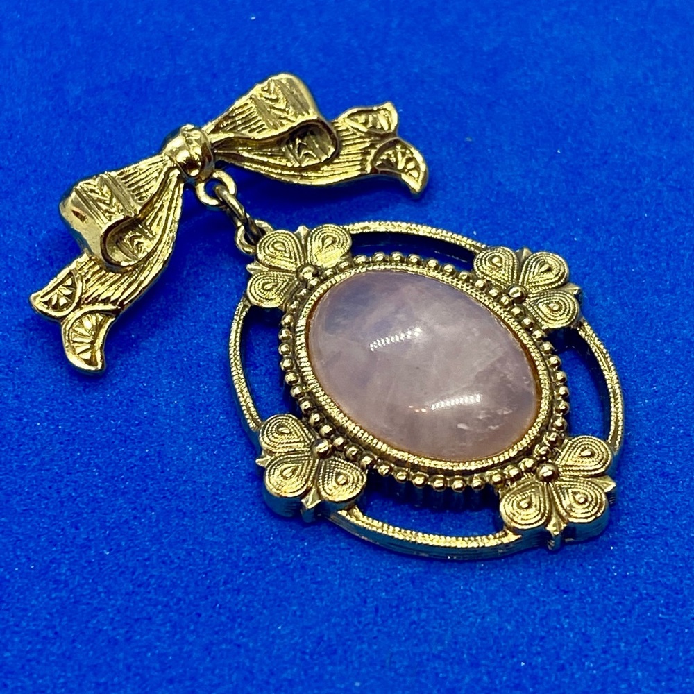 Vintage gold toned broach with a rose quartz stone